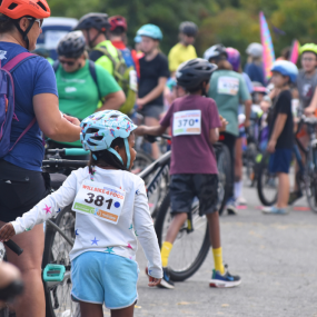 A young girl standing with her bike at Will Bike 4 Food.